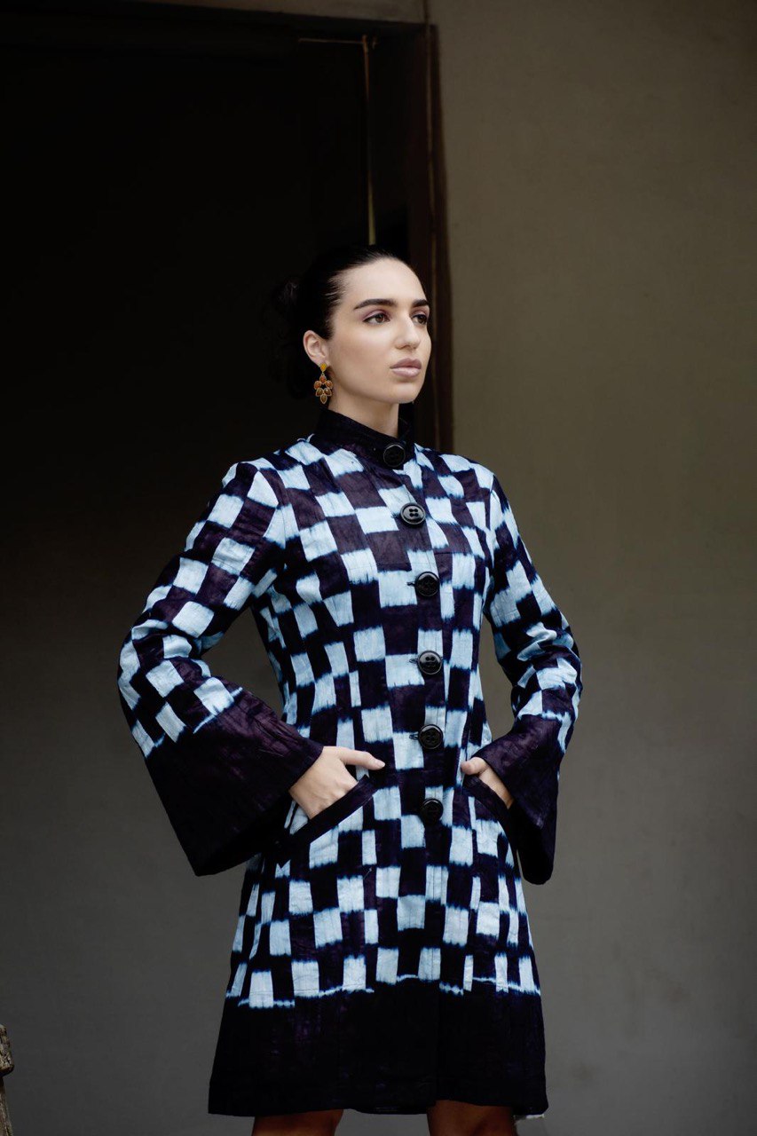 Indigo artisan coat back view — sculptural silhouette — SAAHEL