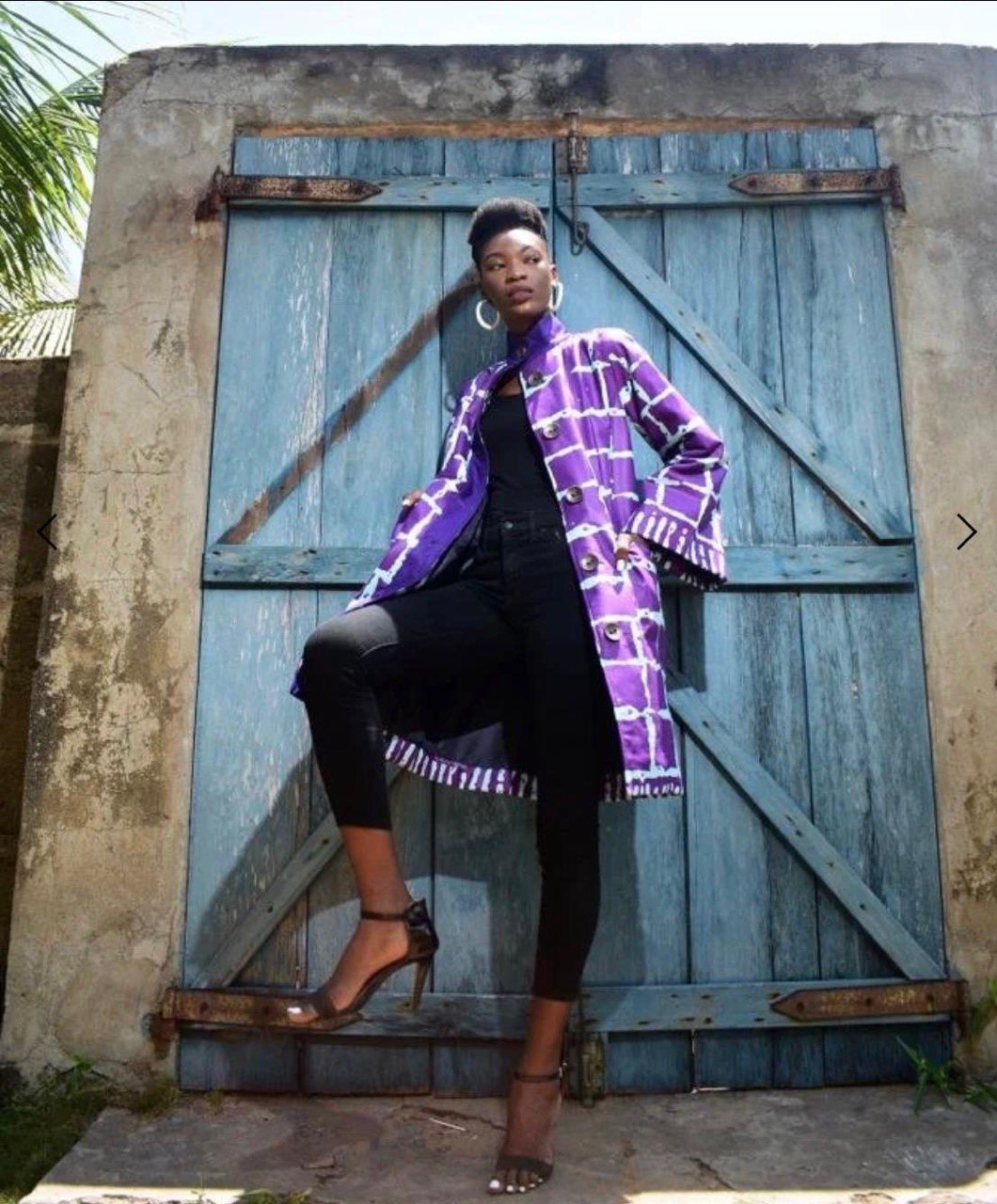 Striking purple Woodin coat back view — structured silhouette — SAAHEL